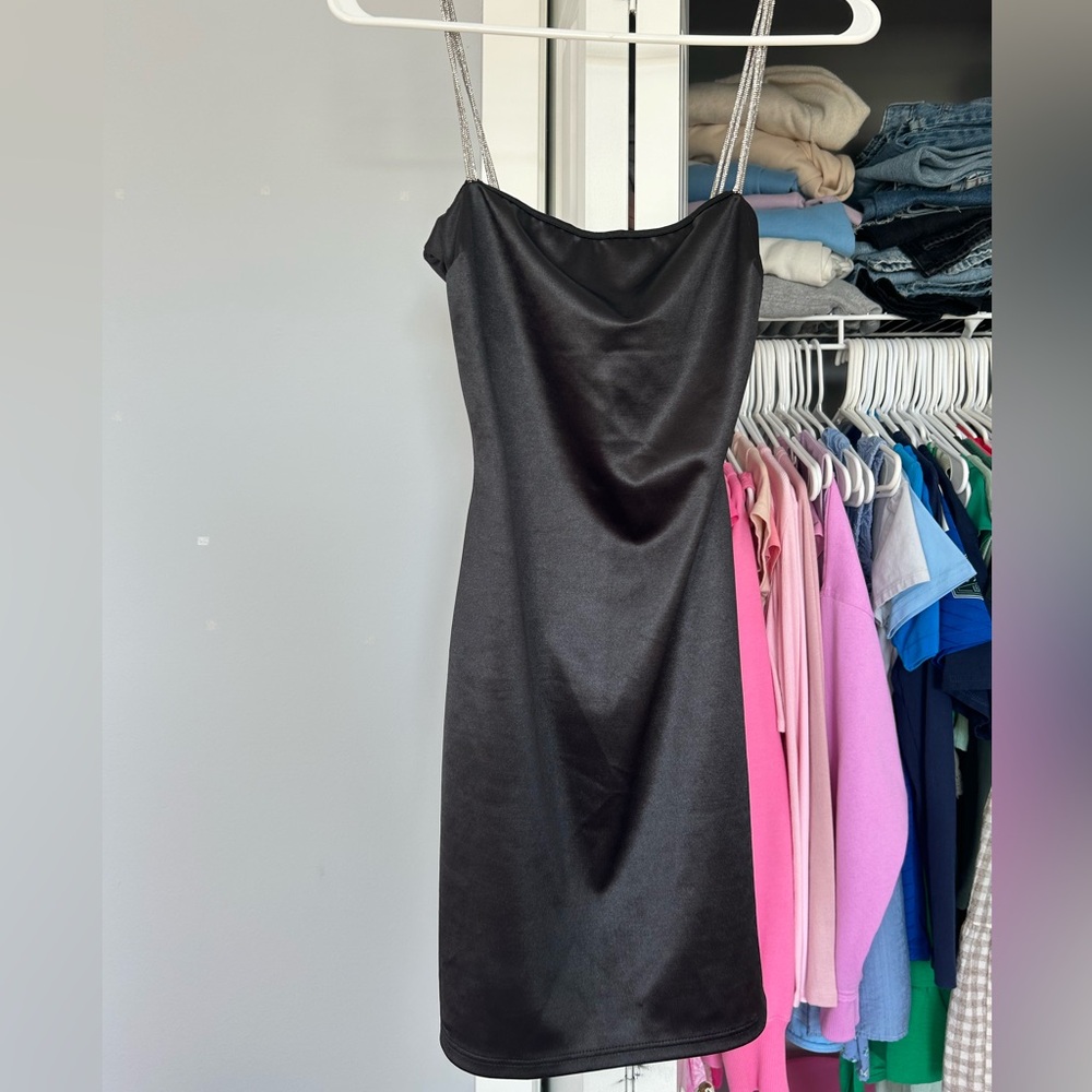 This is a super pretty black dress with silver sparkly straps.